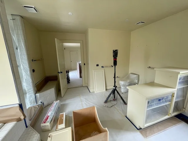 Freshly painted interior room with pale yellow walls and white trim doors